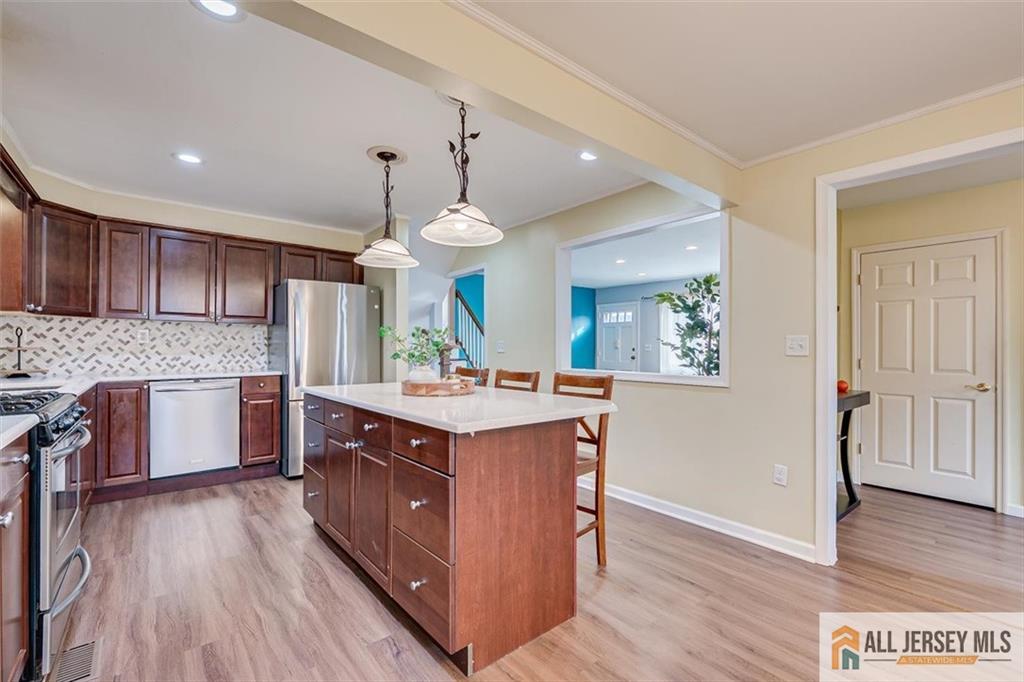 19 Oxford Road East Brunswick, NJ 08816 - Photo 10 of 41 a kitchen with wooden floors and wooden cabinets