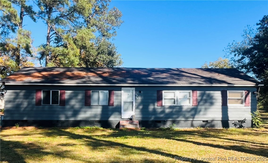 a view of house with swimming pool and yard in the back