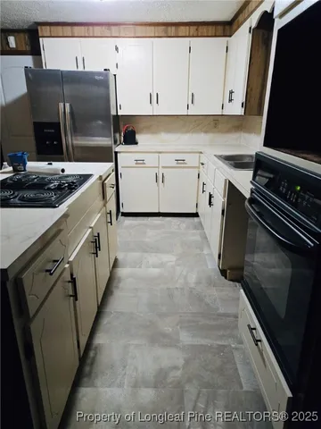 a kitchen with a sink stove and cabinets