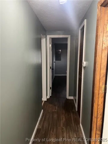 a view of a room with wooden floor