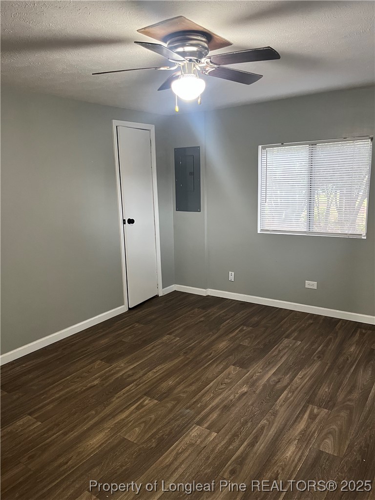 1922 Evergreen Church Road Pembroke, NC 28372 - Photo 25 of 31 an empty room with wooden floor chandelier fan and windows