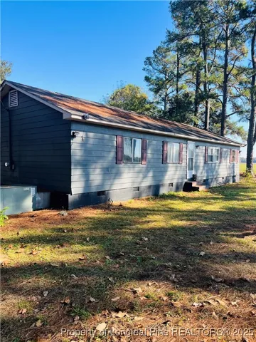 a view of pool table and chairs in front of house
