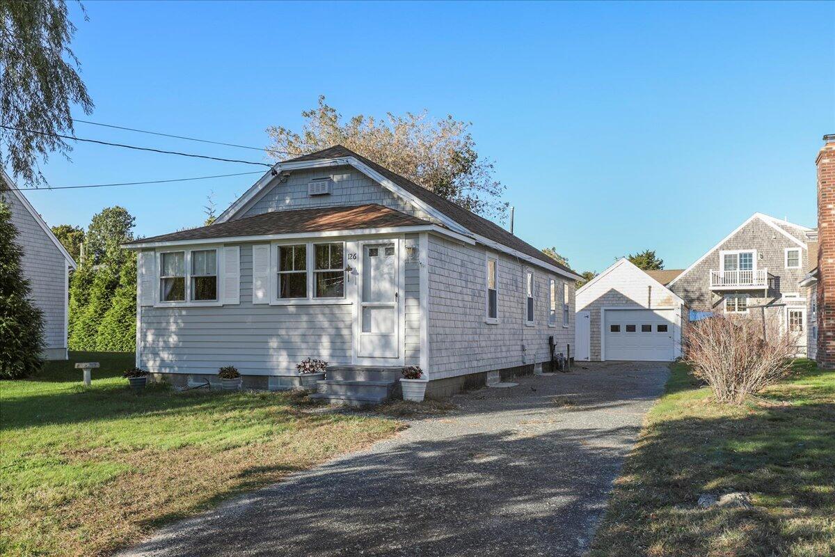 a front view of a house with a garden