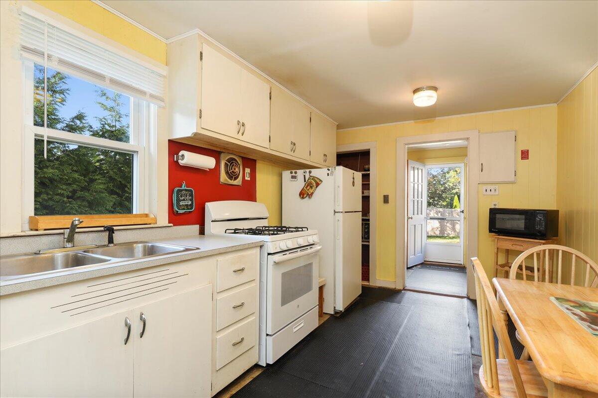 126 Commerce Road Barnstable, MA 02630 - Photo 12 of 30 a kitchen with stainless steel appliances granite countertop a lot of counter space and wooden floors
