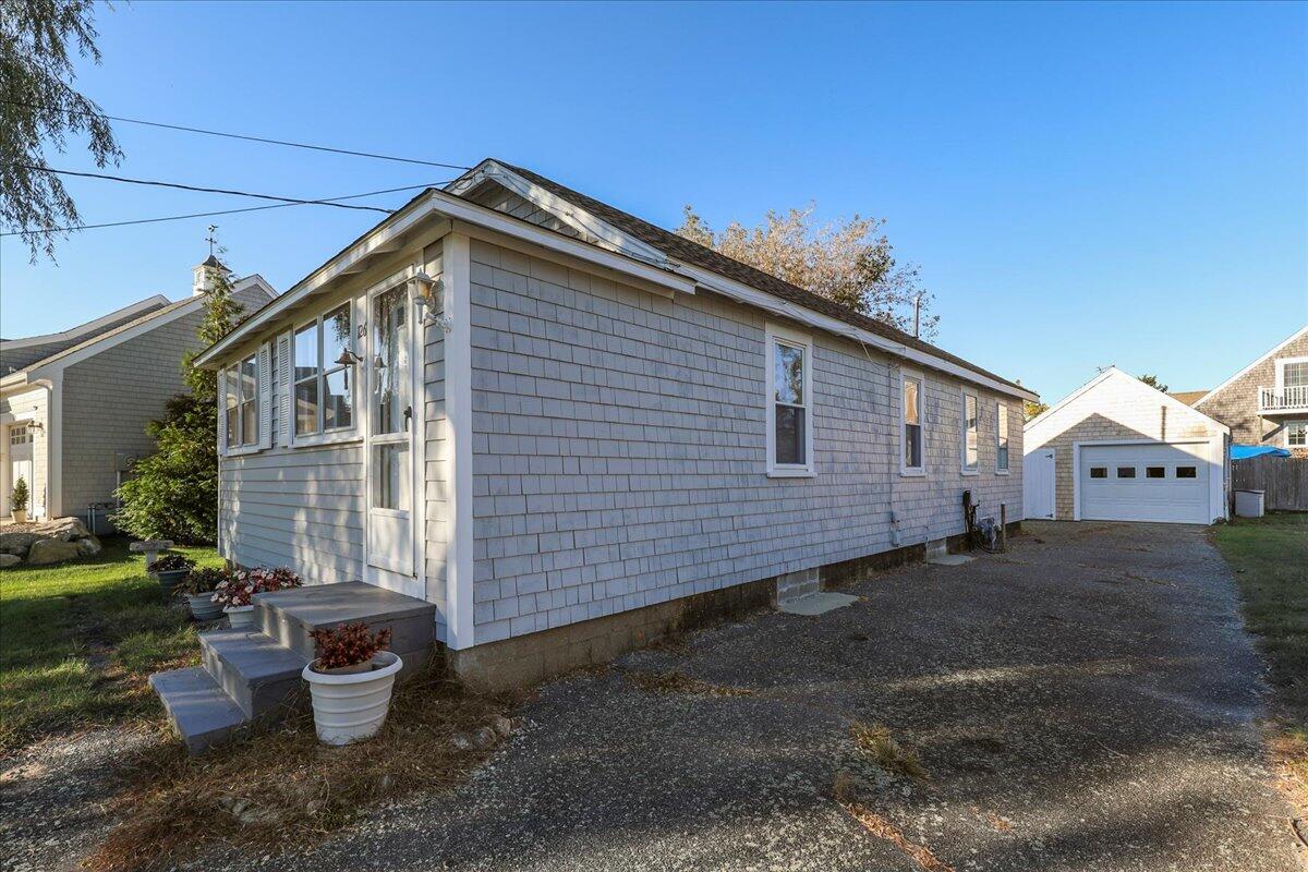126 Commerce Road Barnstable, MA 02630 - Photo 30 of 30 a front view of a house with a yard