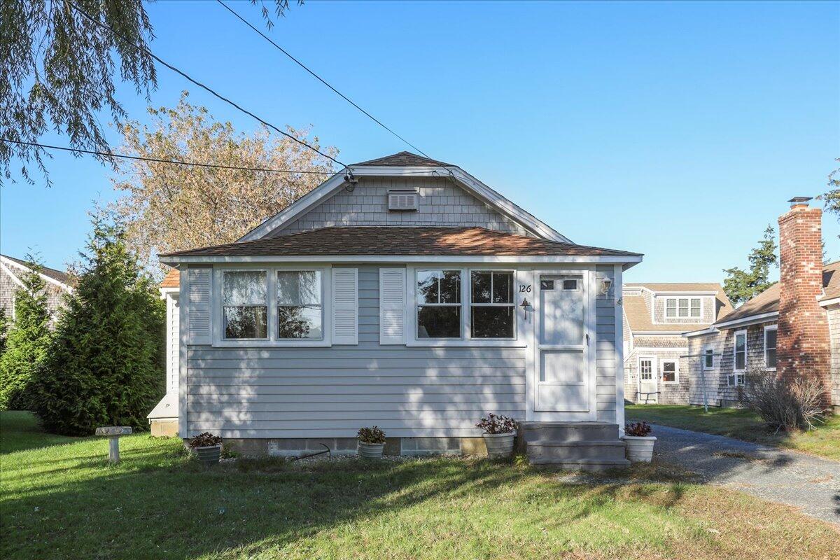 126 Commerce Road Barnstable, MA 02630 - Photo 3 of 30 a front view of a house with a yard