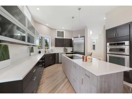 a kitchen with kitchen island a sink stove and refrigerator