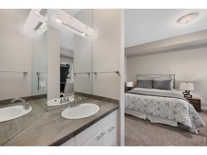 a en suite bathroom with a double vanity sink and a mirror