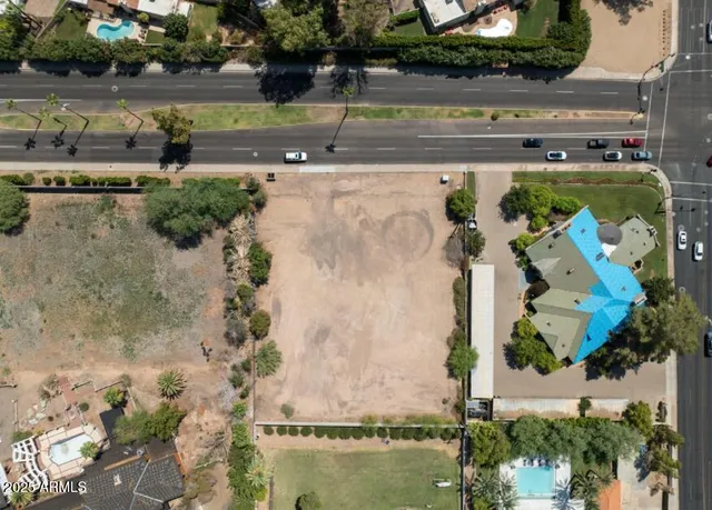 an aerial view of a house with a yard and lake view