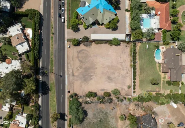 an aerial view of a house with a yard and large trees