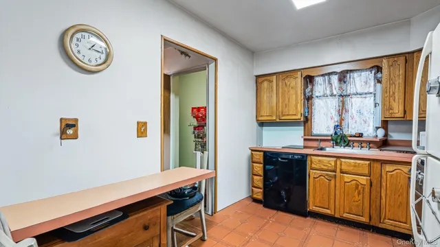a view of a kitchen with fridge and wooden floor
