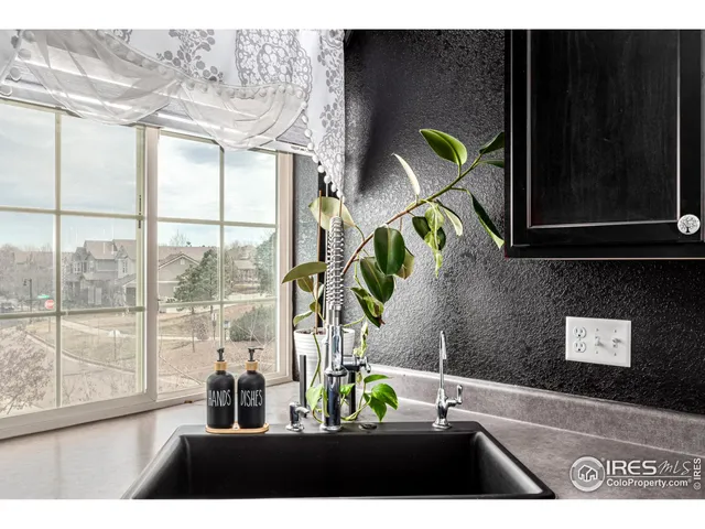 a kitchen with a sink cabinets and stainless steel appliances
