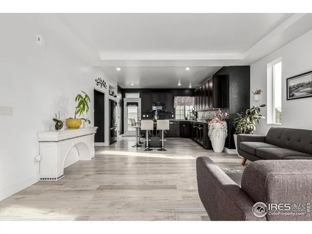 a living room with furniture and a kitchen area