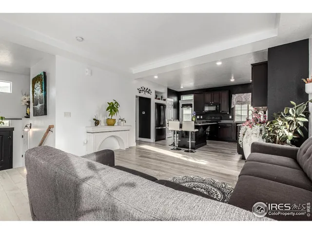 a living room with furniture kitchen view and a fireplace
