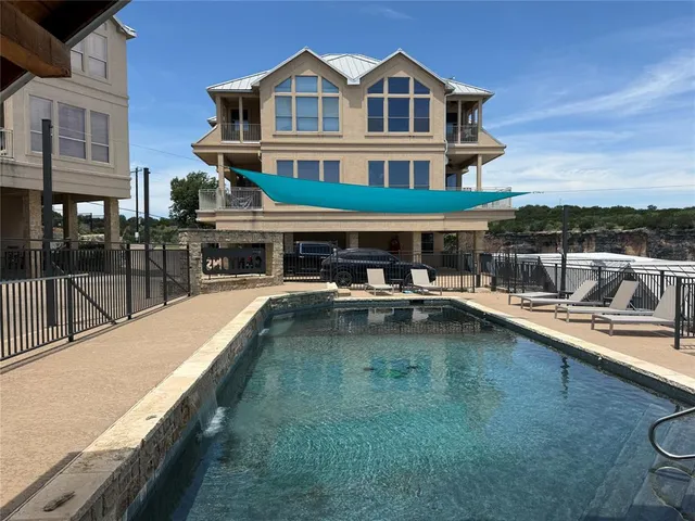 a view of a swimming pool with a lounge chair