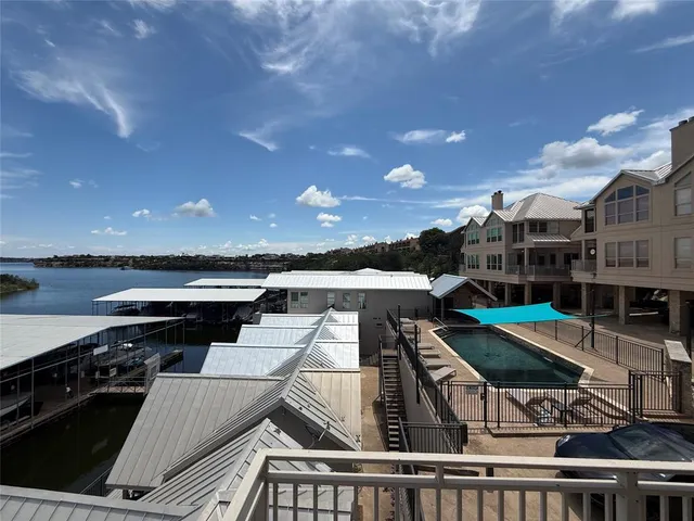 a roof deck with table and chairs a barbeque