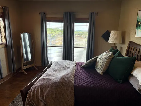 a bedroom with a bed and windows