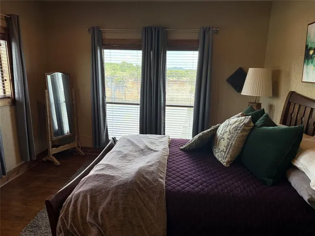 a bedroom with a bed and windows