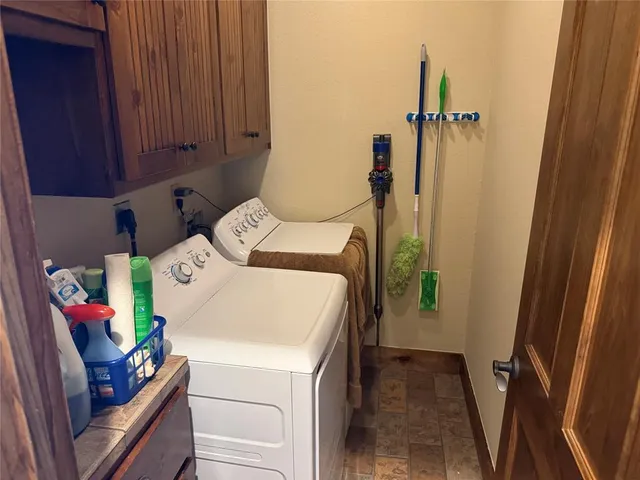 a large bedroom with a bed and wooden floor