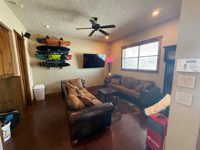 a living room with furniture ceiling fan and a window