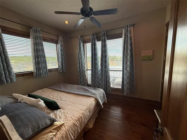 a bedroom with a bed next to a window