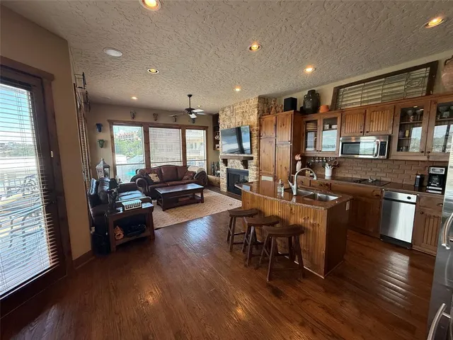 a living room with furniture and kitchen view