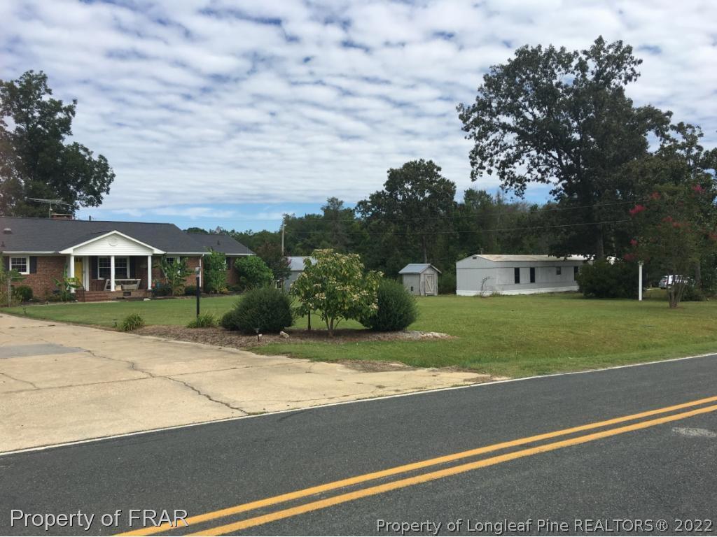 5765 Stewart Road Wade, NC 28395 - Photo 1 of 22 a front view of a house with a yard