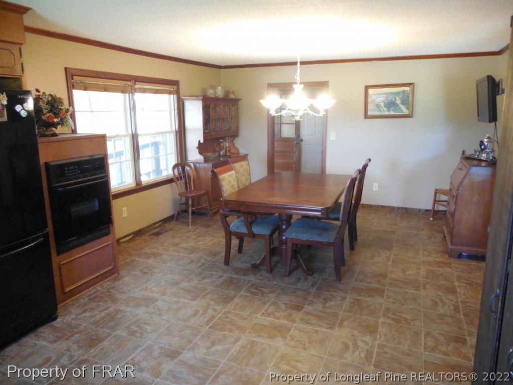 5765 Stewart Road Wade, NC 28395 - Photo 8 of 22 a view of a dining room with furniture