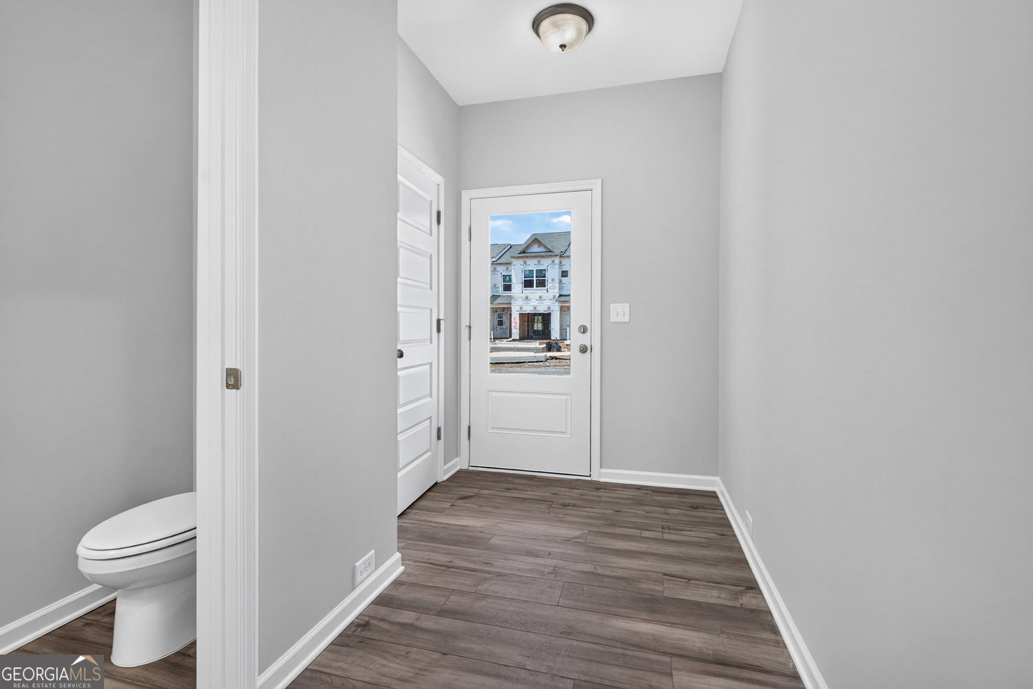 155 Oconee Road, Unit 252 Cartersville, GA 30120 - Photo 4 of 39 a view of a hallway with wooden floor and a toilet