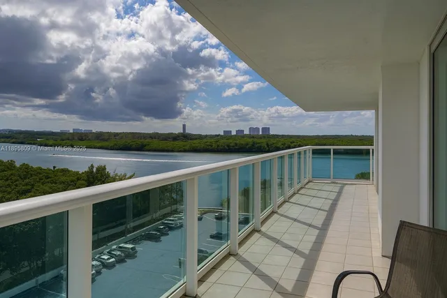 a balcony with wooden floor and lake view