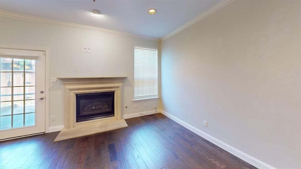 18240 Midway Road, Unit 1204 Dallas, TX 75287 - Photo 22 of 27 an empty room with wooden floor and fireplace