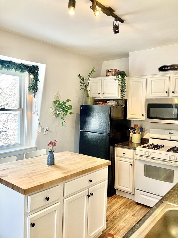 946 Bay Road, Unit 3 Hamilton, MA 01982 - Photo 2 of 13 a kitchen with a sink appliances and cabinets