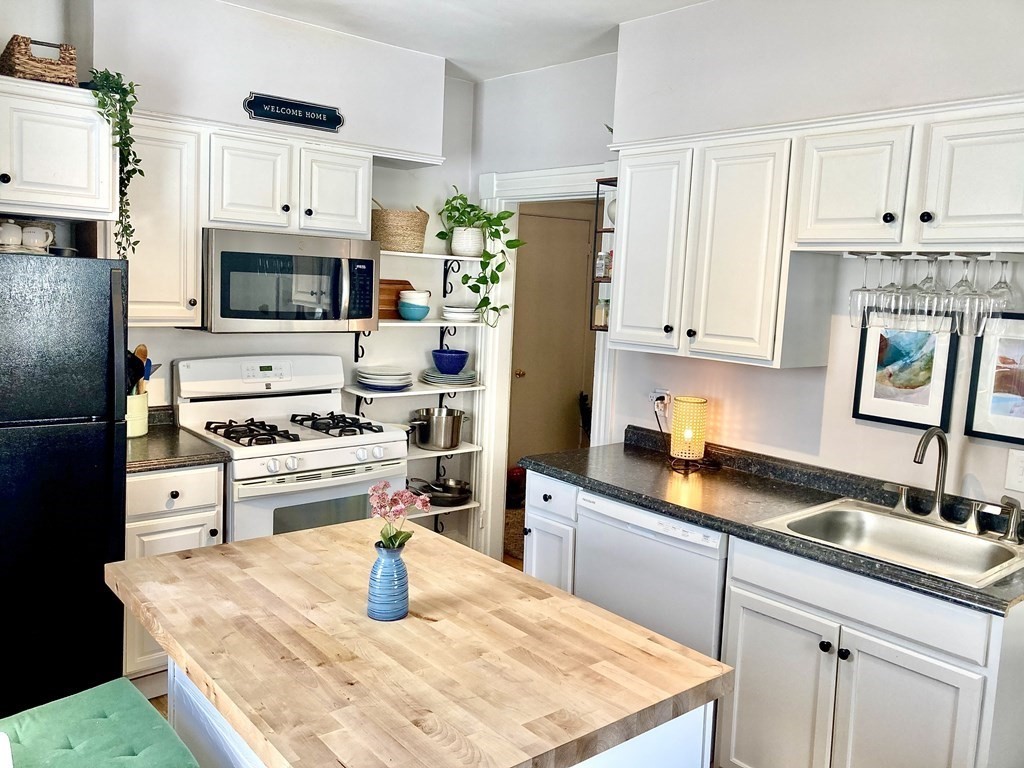 946 Bay Road, Unit 3 Hamilton, MA 01982 - Photo 3 of 13 a kitchen with stainless steel appliances granite countertop a sink stove and refrigerator