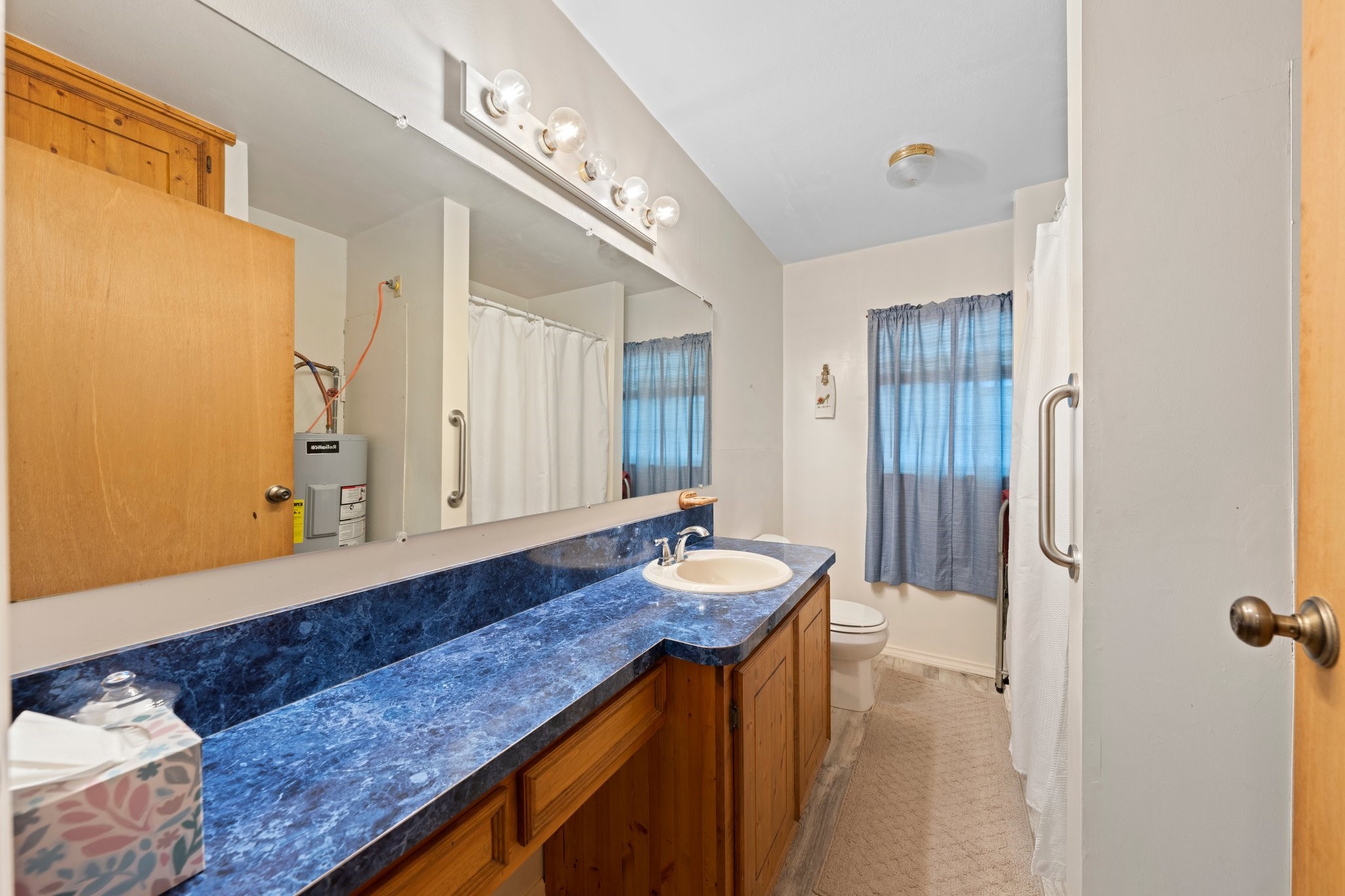 208 Francisco Lemos Street Kerrville, TX 78028 - Photo 17 of 29 a bathroom with a granite countertop sink and a mirror