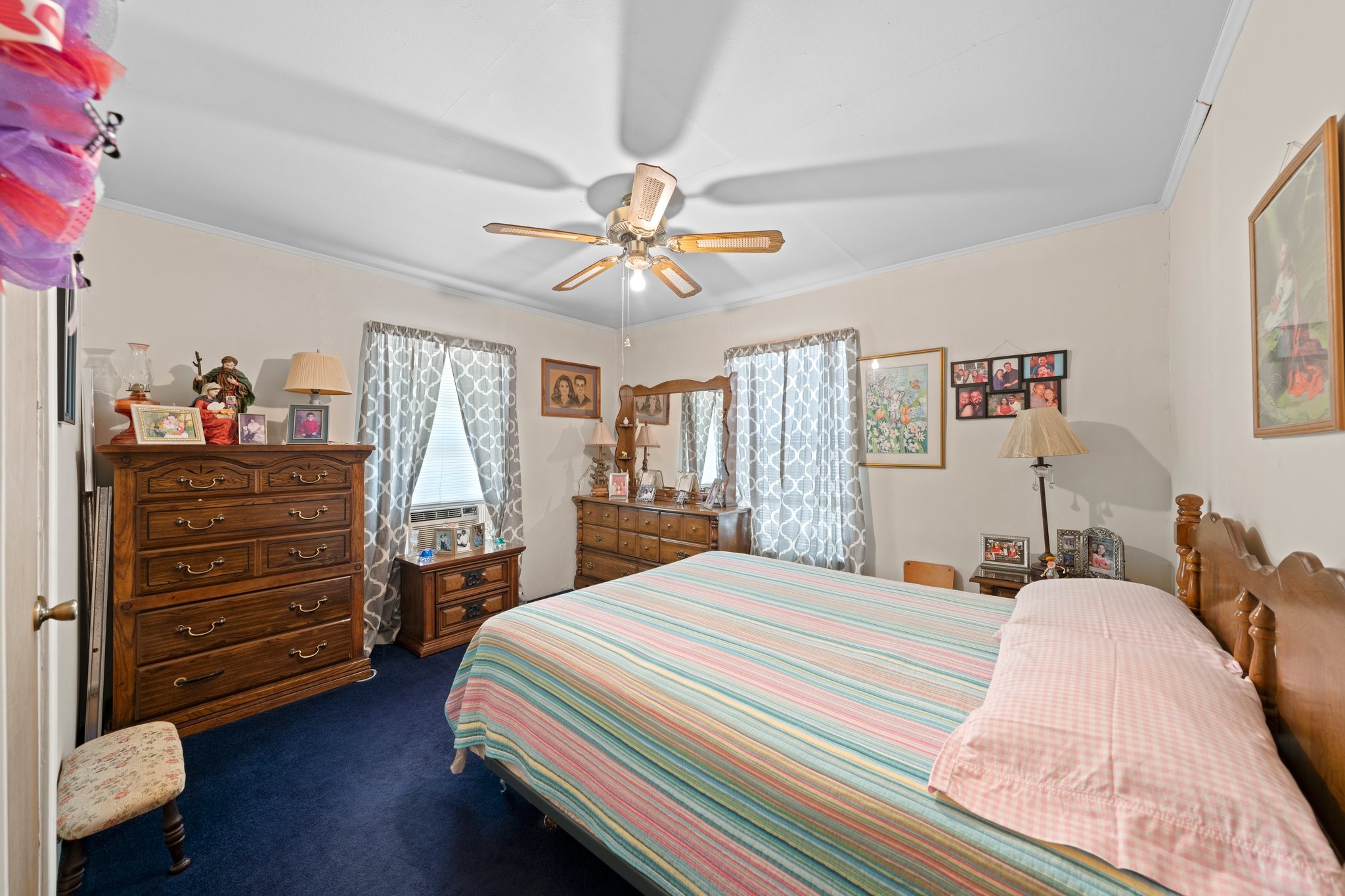 208 Francisco Lemos Street Kerrville, TX 78028 - Photo 19 of 29 a bedroom with a bed and a chandelier