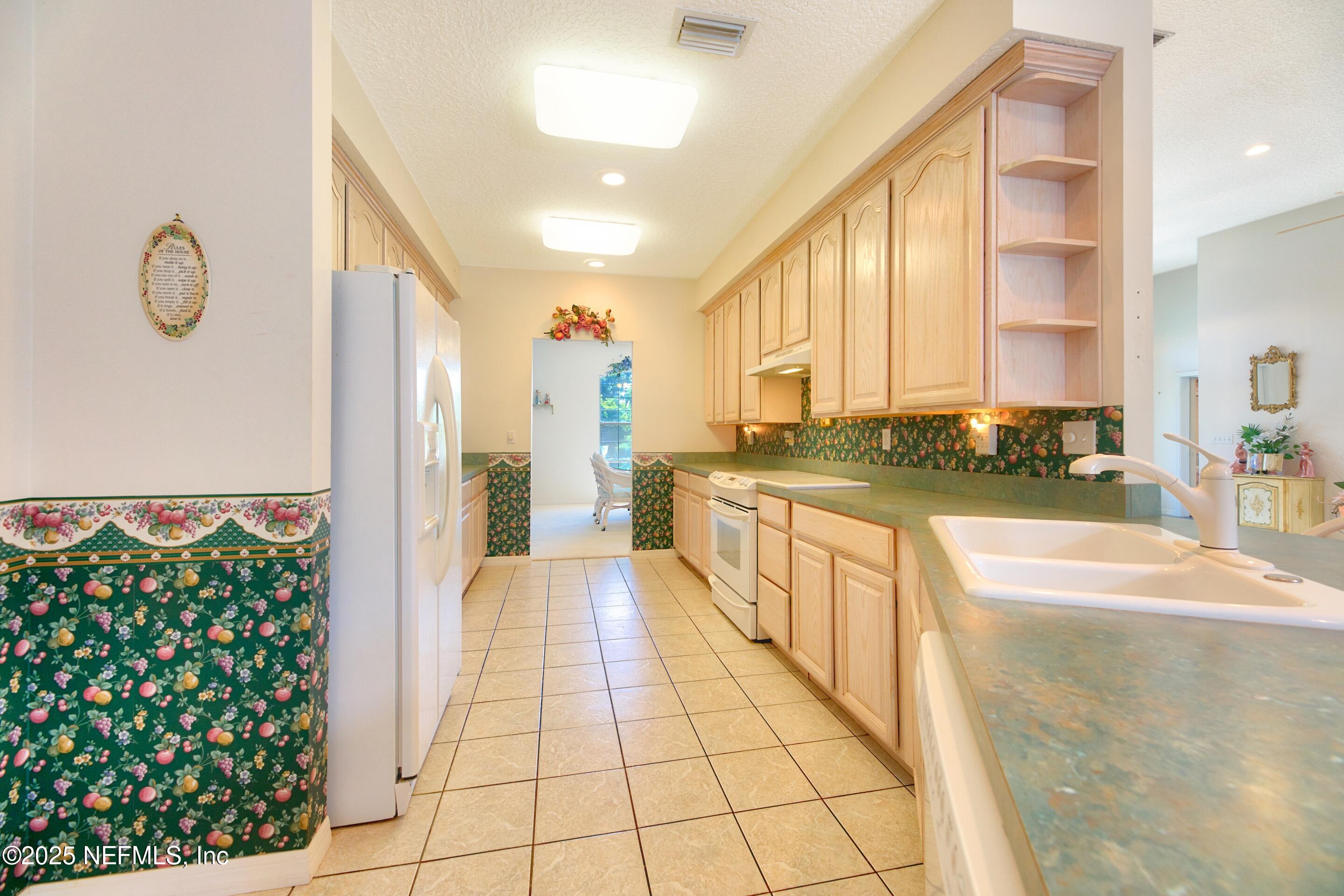 430 Marsh Point Circle St. Augustine, FL 32080 - Photo 19 of 69 a large white kitchen with granite countertop a large window and a counter top space