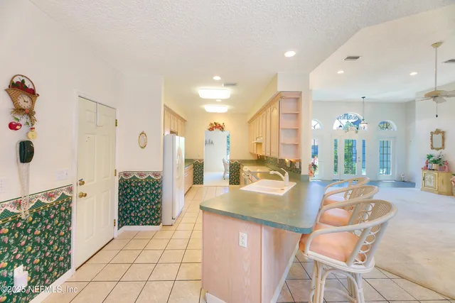 a spacious bedroom with a bed and a chandelier