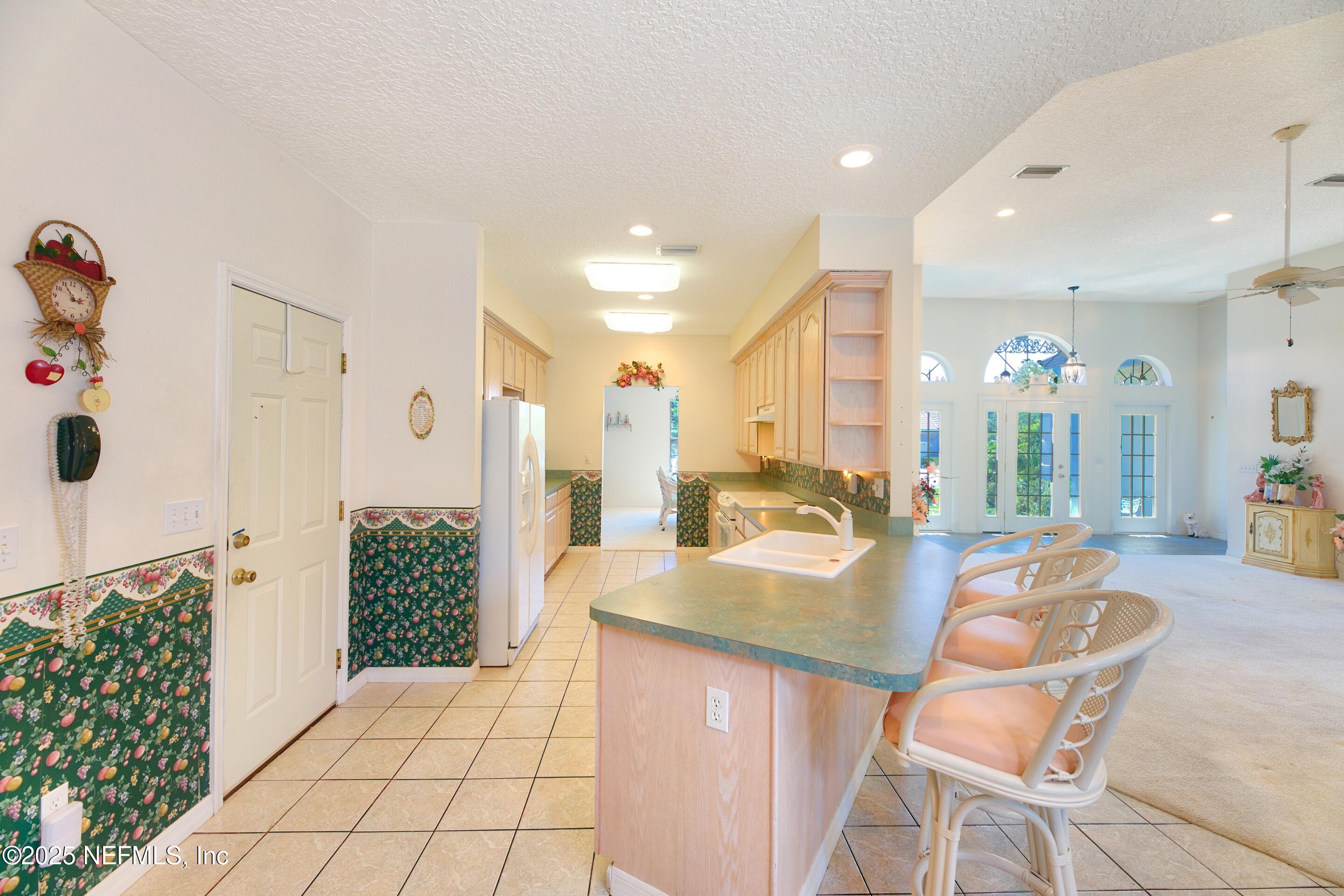 430 Marsh Point Circle St. Augustine, FL 32080 - Photo 20 of 69 a dining hall with stainless steel appliances granite countertop a refrigerator and a sink