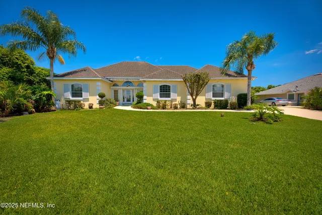 a front view of a house with a garden