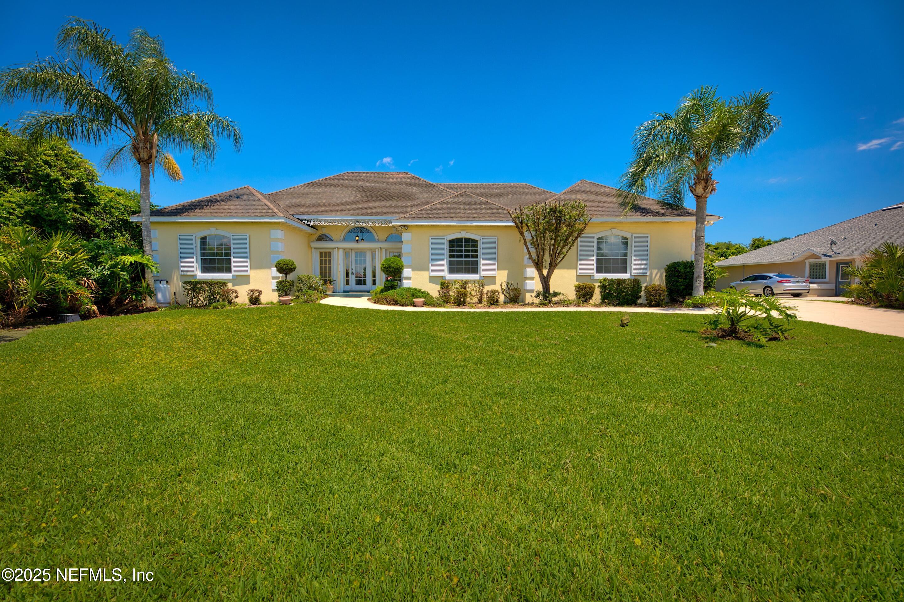 430 Marsh Point Circle St. Augustine, FL 32080 - Photo 2 of 69 a front view of a house with a garden