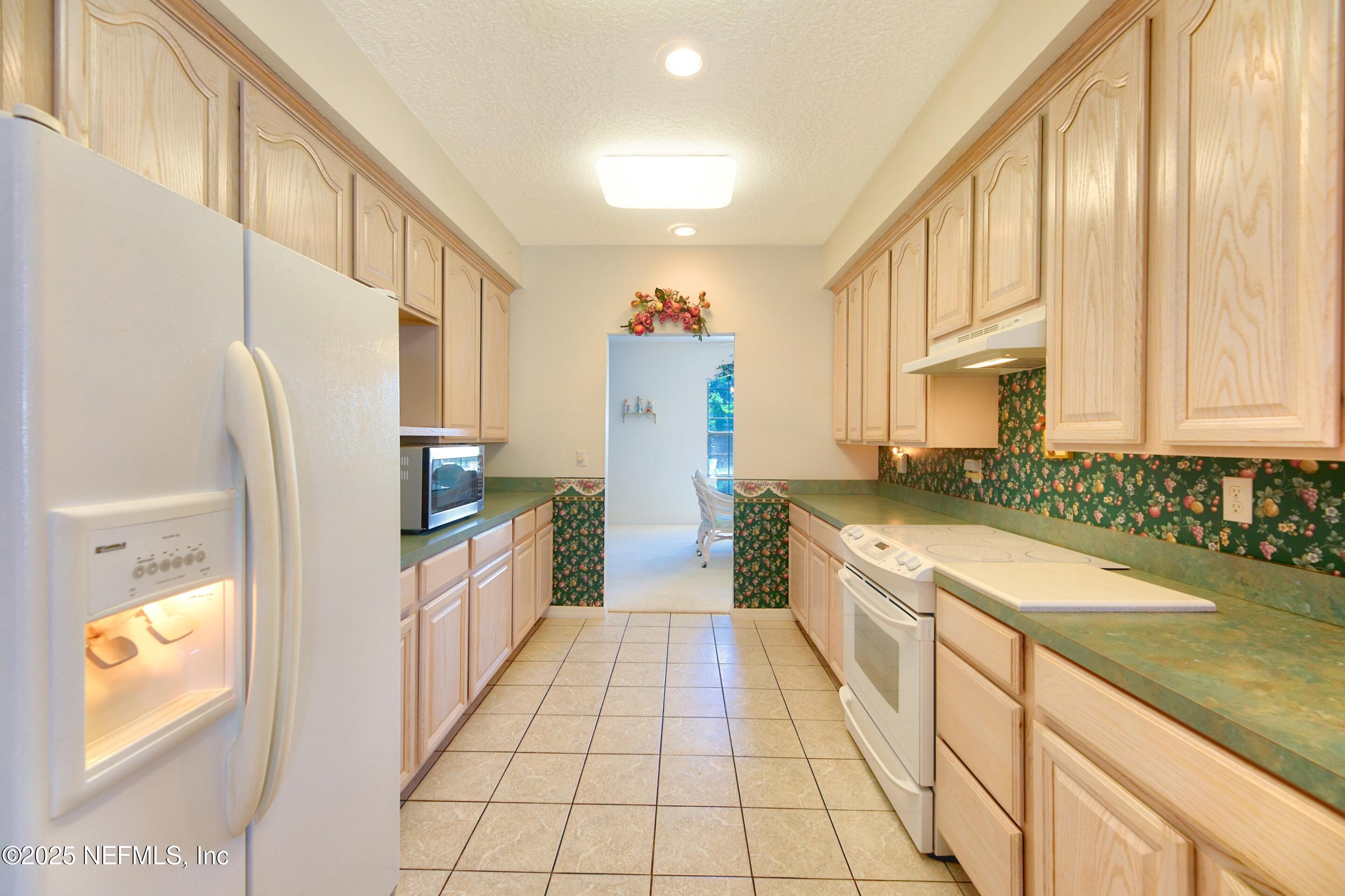 430 Marsh Point Circle St. Augustine, FL 32080 - Photo 21 of 69 a large kitchen with a sink and cabinets
