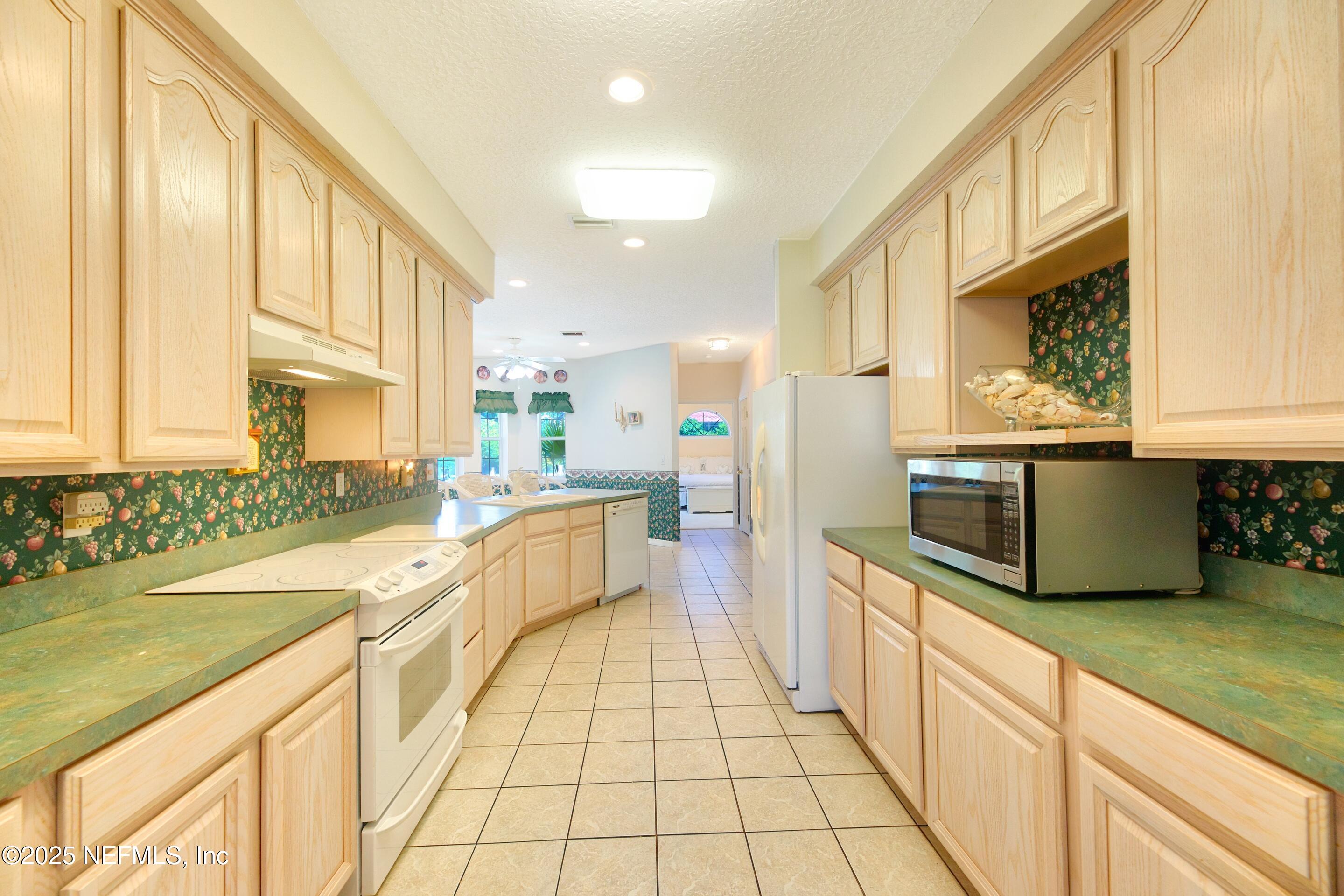 430 Marsh Point Circle St. Augustine, FL 32080 - Photo 25 of 69 a large kitchen with stainless steel appliances granite countertop a sink and cabinets