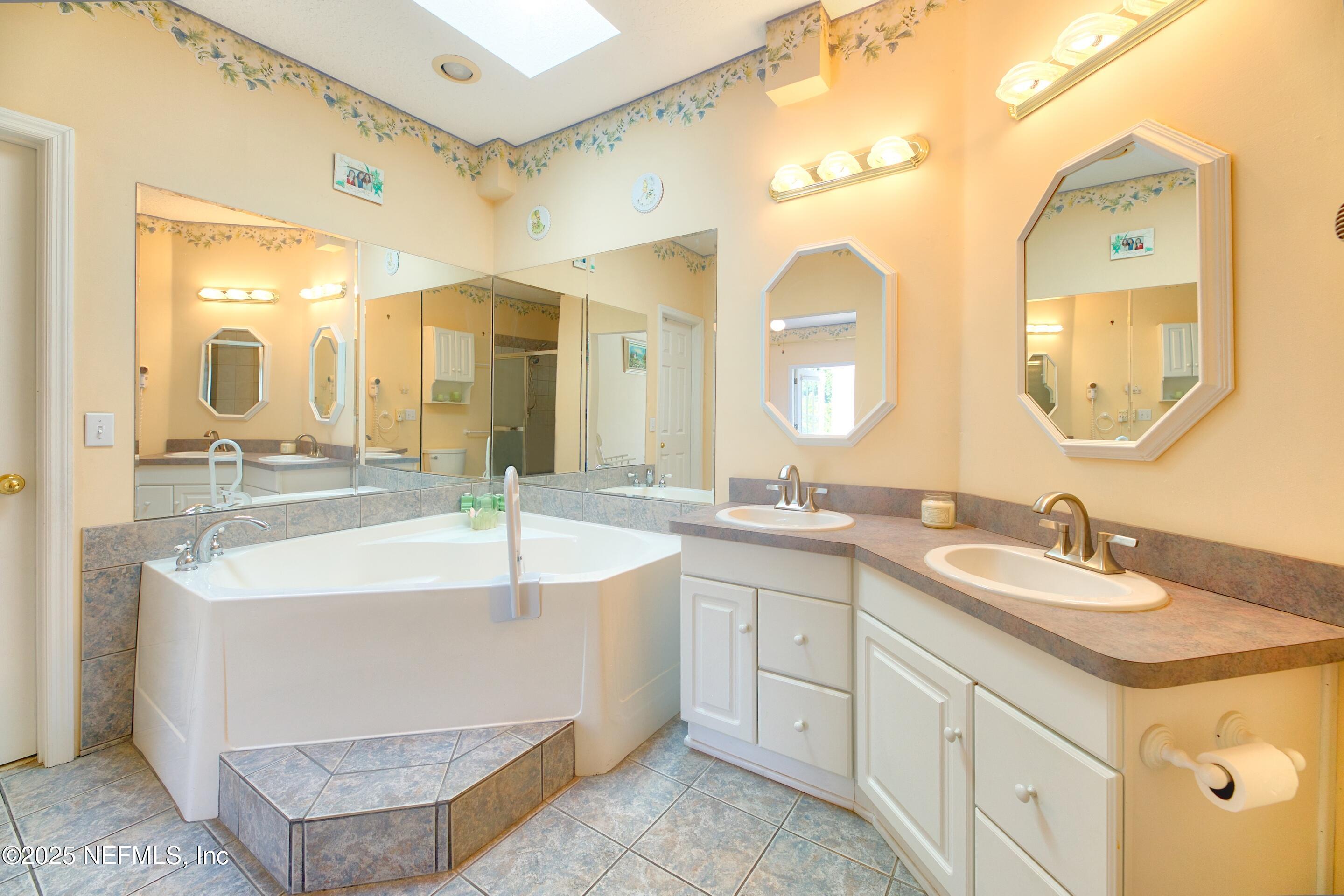 430 Marsh Point Circle St. Augustine, FL 32080 - Photo 31 of 69 a bathroom with a sink and a mirror