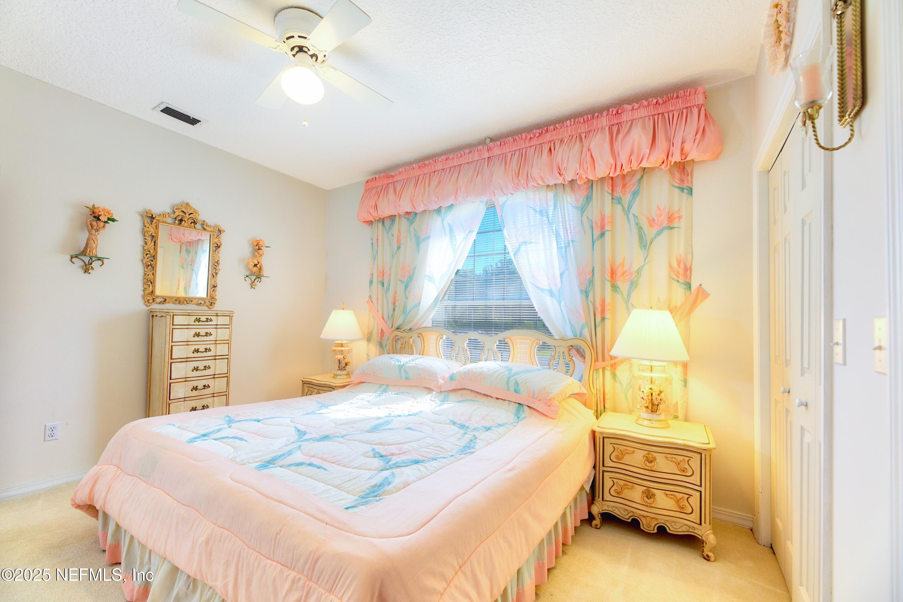 430 Marsh Point Circle St. Augustine, FL 32080 - Photo 34 of 69 a bedroom with a bed and a chandelier