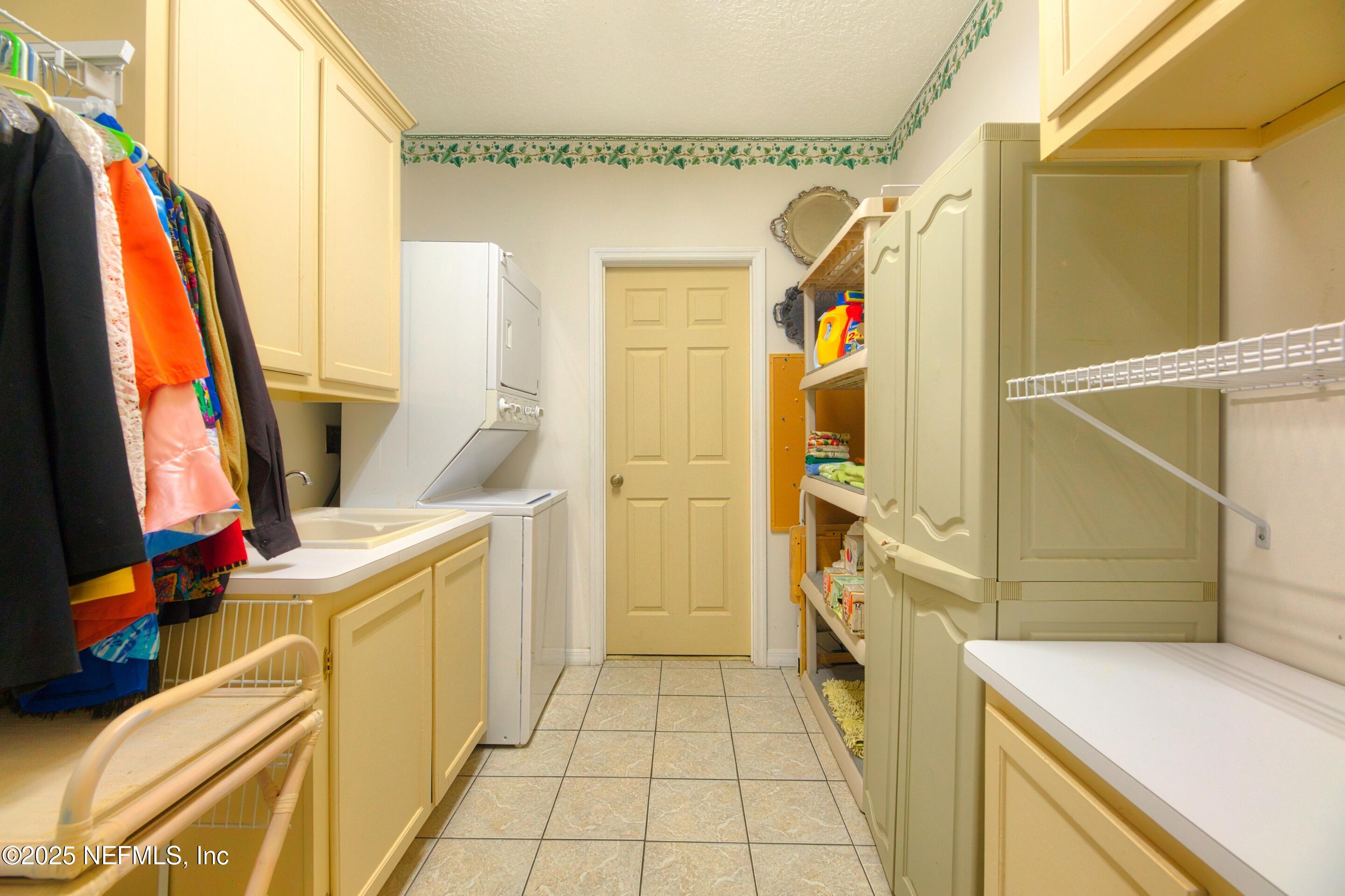 430 Marsh Point Circle St. Augustine, FL 32080 - Photo 49 of 69 a view of walk in closet with clothes and shoes