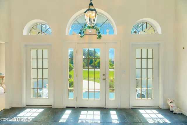 a view of a dining room with furniture and a chandelier fan