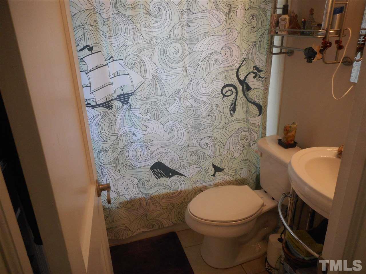 2306 Bernard Street, Unit 2306 Raleigh, NC 27608 - Photo 5 of 13 Ceramic tile bath surround with updated pedestal sink