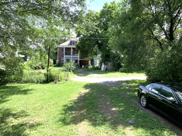 a view of a backyard with swimming pool