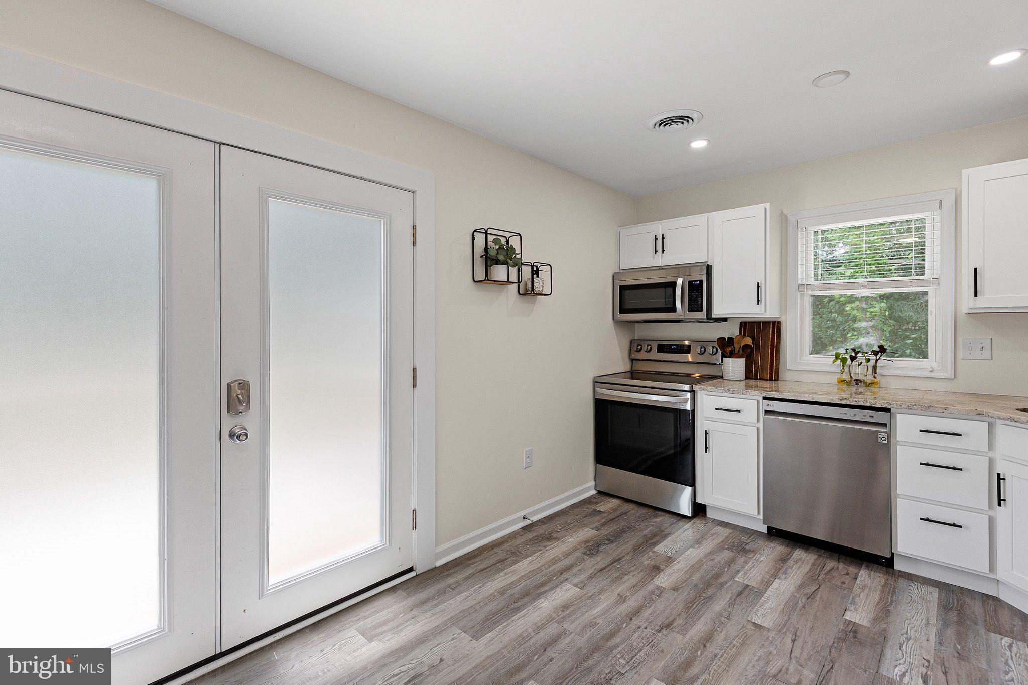 370 Big Elk Chapel Road Elkton, MD 21921 - Photo 13 of 29 a kitchen with granite countertop a refrigerator stove and sink