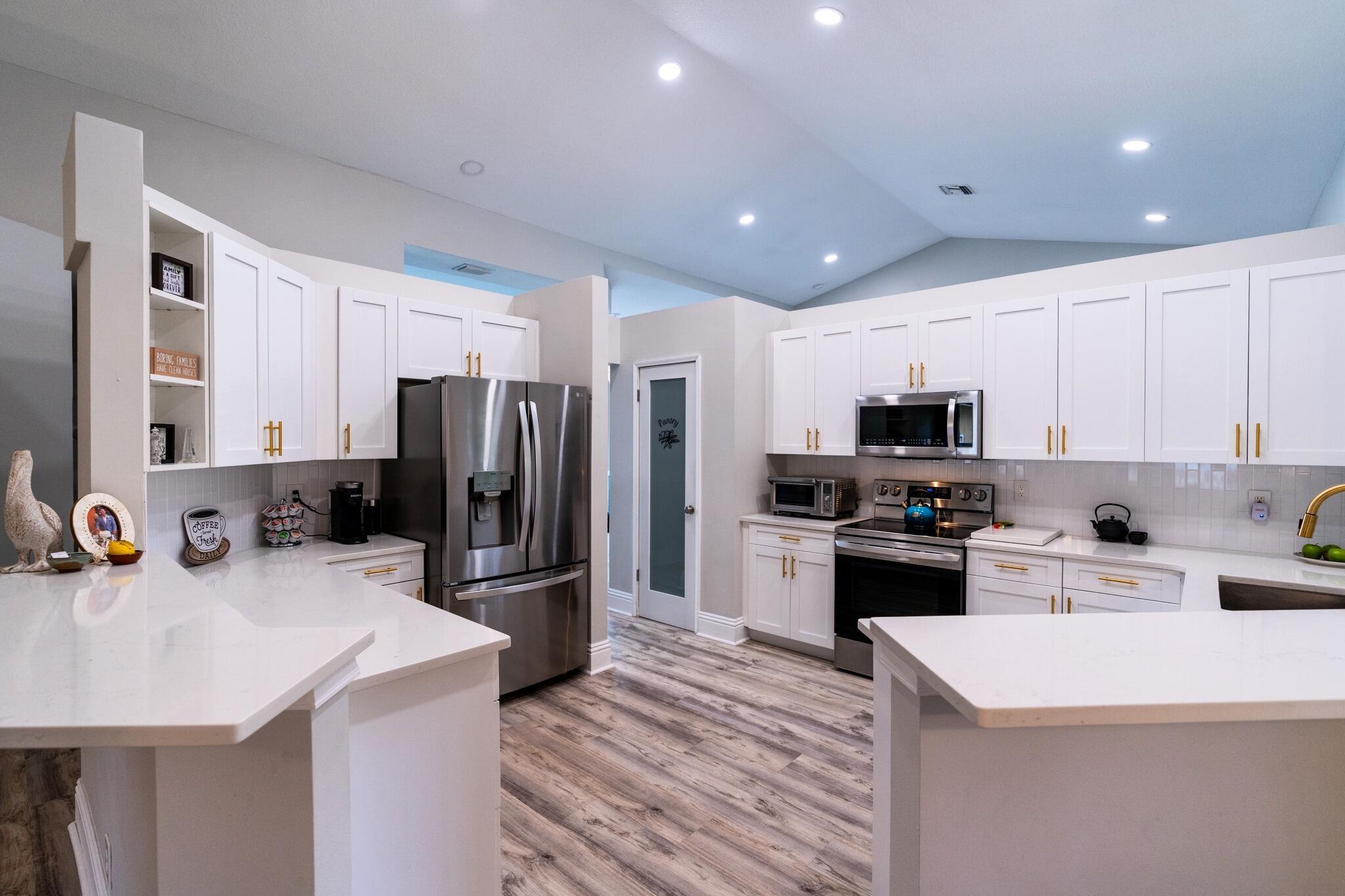 22392 Siesta Key Drive Boca Raton, FL 33428 - Photo 11 of 39 a kitchen with refrigerator a sink and a stove
